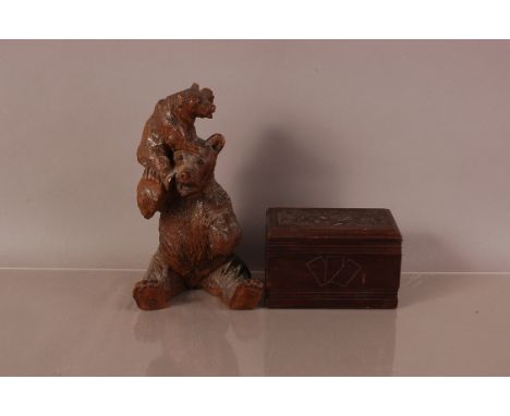 A late 19th century Black Forest carved bear group, 20cm, some damages, together with a playing card box with two unopened pa