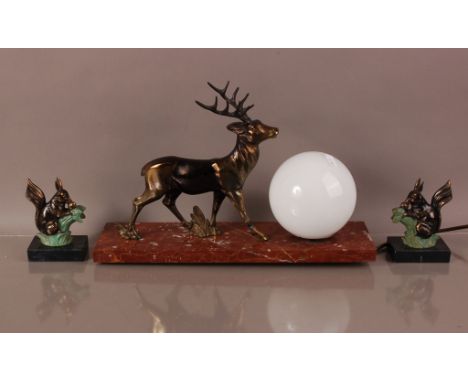 An Art Deco style figural lamp base, 38cm wide, red marble base with applied deer, loose, and spherical glass shade, together