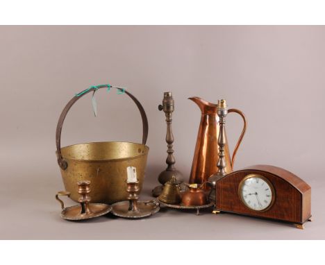 An assortment of metalware, to include a pair of worn Sheffield plated chamber sticks, a pair of lamp bases, a water jug, and