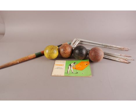 A vintage Croquet set, comprisng four mallets, four balls, six cast iron hoops, coloured centre stake and instruction manual 