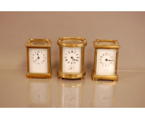 Three vintage brass carriage timepieces, one oval example with bell to underside, one with cracked dial (3)