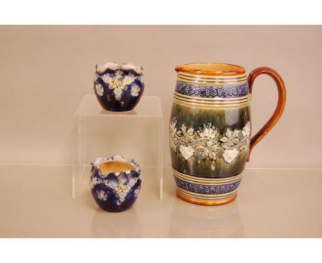 A Royal Doulton stoneware pitcher, 23cm high, together with a small pair of Royal Doulton stoneware posy vases (3)
