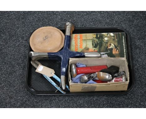 A tray containing silver-smithing tools together with a related book