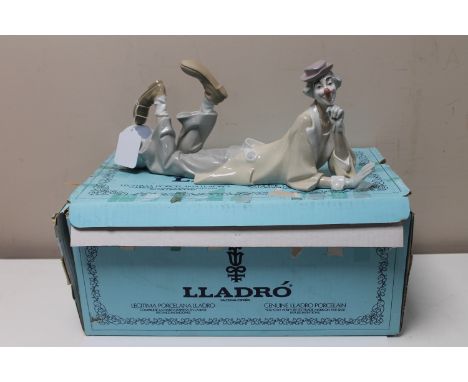 A Lladro china figure : Clown Reclining with Ball, model number 4618, designed by Salvador Furio, issued 1970, height 16 cm, 