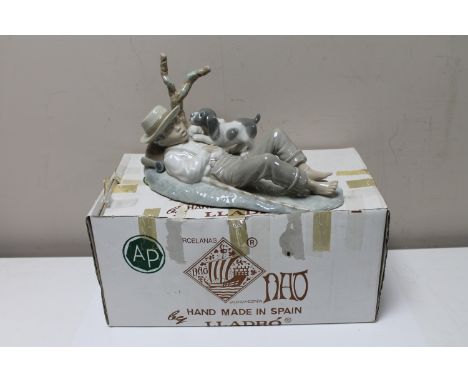 A Nao china figure : A Young Boy Sleeping by a Tree with a Puppy, height 15 cm,  length 25 cm. 