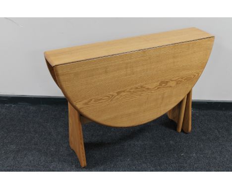 An Ercol elm gateleg table 