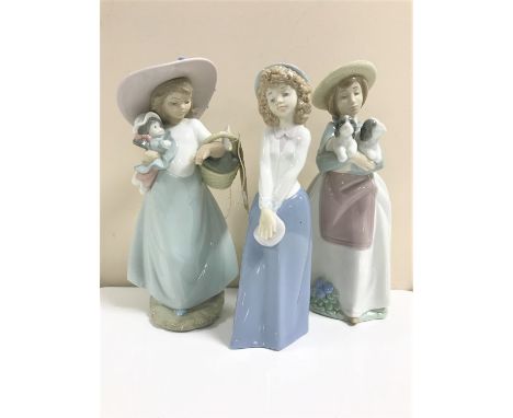 Three Nao figures; girl with doll and basket, girl carrying puppies and girl with purse 