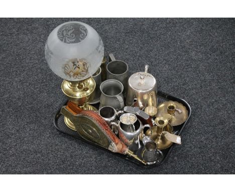 A tray of brass oil lamp with shade, brass embossed bellows, plated wares, pewter tankards, brass candlesticks etc