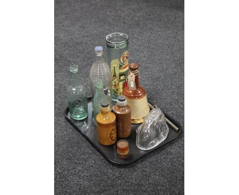 A tray containing antique stoneware and glass bottles, an antique glass jelly mould of a rabbit, spaghetti jar, a Wade Bell's