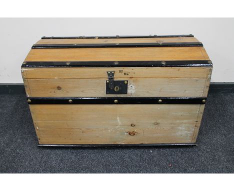 An early 20th century pine domed topped shipping trunk 