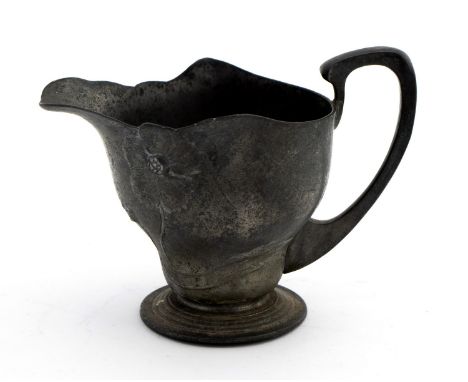 An Art Nouveau pewter jug, relief molded poppies on footed base 