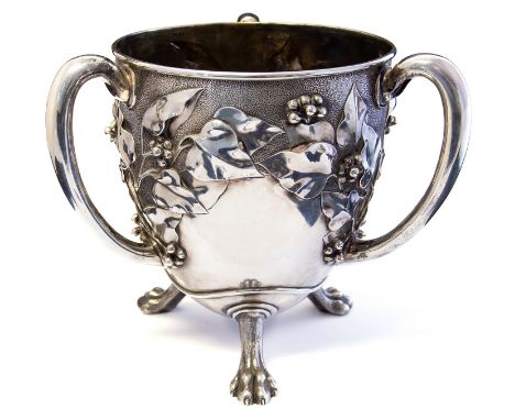An Art Nouveau silver three-handled cup, egg form embossed in high relief with fruiting vine, the top half textured, three op