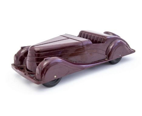 Codeg, an Art Deco Bakelite model car,circa 1930, maroon, with black wheels, lacking windscreen, 34.5cm long