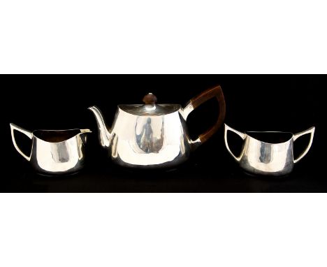 A Modernist silver three piece tea set, ovoid form with wishbone handles, and hardwood finial, Rodney C Pettit, London 1977, 