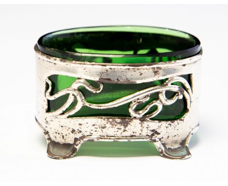 An Arts and Crafts silver salt cellar, pierced sinuous tendril design in the Art Nouveau style, on bracket feet, green glass 