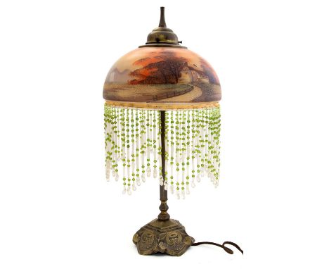 An Art Deco style brass table lamp with hand painted glass shade, circa 1920, in the style of Legras, the domed shade with be