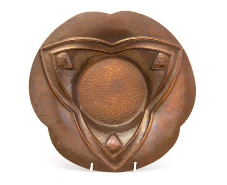 Noel Collet, an Art Deco repousse copper dish, planished and hammered with geometric trefoil design, signed and stamped, 32cm