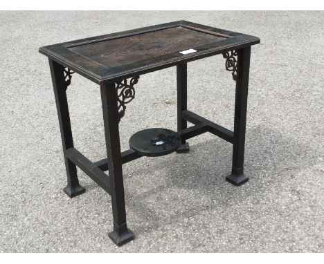 An Aesthetic Movement ebonised oak and cast metal occasional table, the plank top supported on square section legs with cast 