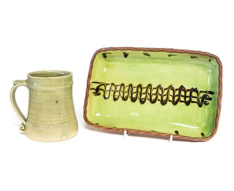 Leach Pottery, a St Ives celadon glaze, standard ware tankard; together with a Winchcombe studio pottery slip decorated dish,