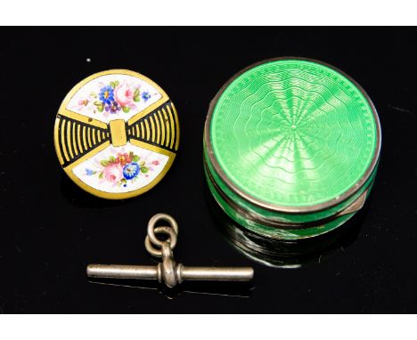 An Art Deco silver and enamelled compact, apple green guilloche enamel, circular form with mirrored interior, import marks, L