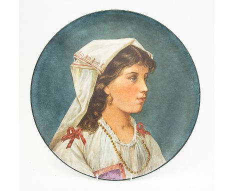 Howell & Jones, an Art Pottery charger with cold painted portrait of a woman in traditional country clothes, 42cm diameter