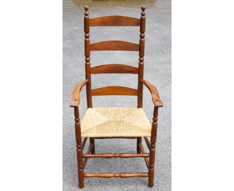 Ernest Gimson, a pair of yew wood ladder back and bobbin turned armchairs, rush seats, circa 1915 (2)Note: made as a special 