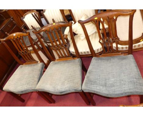A set of six contemporary mahogany Chippendale style dining chairs, each having fabric and studded stuff over seats of genero