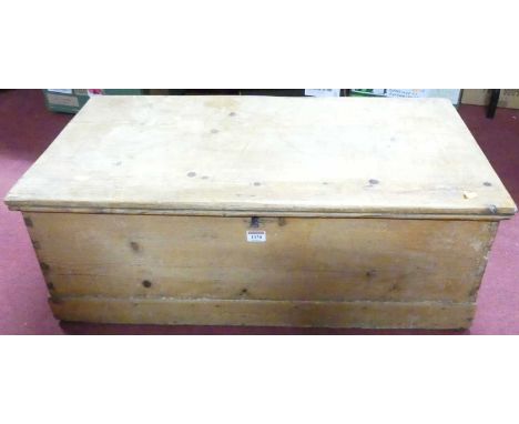 A rustic pine hinge top tool chest, having iron end carry handles, width 82cm