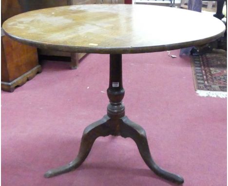 An early 19th century provincial oak circular tilt-top pedestal tripod table, dia. 86cm