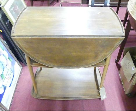 An Ercol blond elm drop flap three-tier tea trolley
