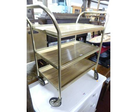 A gilt metal three-tiered tea trolley, on roller castors, width 70cm