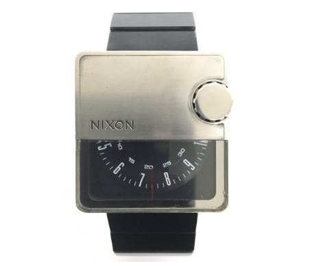 A Nixon The Murf gents wristwatch. This modern design wristwatch is of unusual square design, with rotating black dial with b