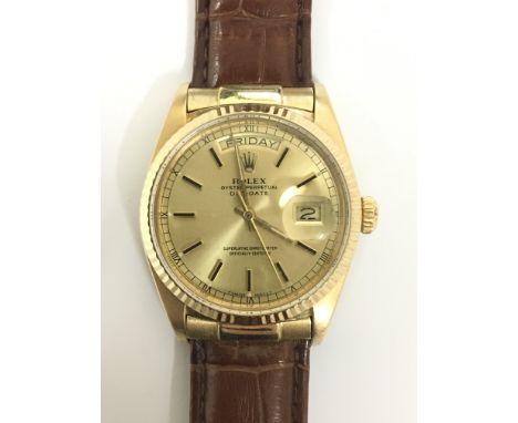 A Rolex Oyster Perpetual Day-Date chronometer wristwatch. This gents 18ct gold wristwatch presents a uniform gold tone dial w