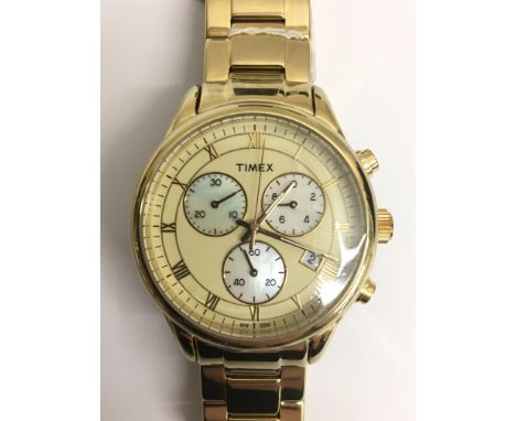 A ladies Timex chronograph wristwatch. The gold tone dial presenting three pearlescent subsidiary dials and Roman numerals. M