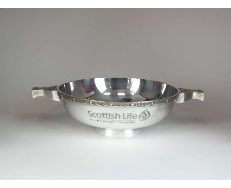 A silver presentation quaich, Mappin & Webb, Sheffield 1997, with two Celtic design handles and border, raised on collet foot