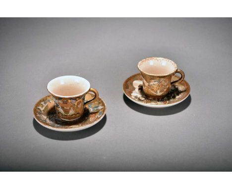 Two similar Japanese Satsuma demitasse and saucers, Meiji periodThe cups of trumpet form with plain loop handle, the first de