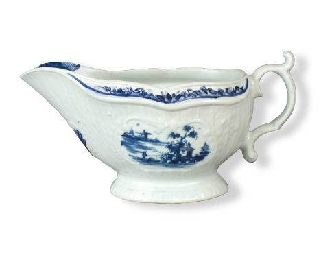 A Worcester sauce boatcirca 1760-65of press-moulded form with foliage cartouches, painted in blue with the 'Fisherman and Bil