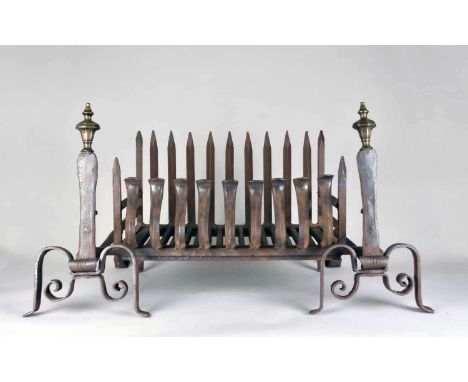 A pair of wrought iron fire dogs, 17th centuryOf scroll form with brass finials, together with a reproduction wrought iron fi