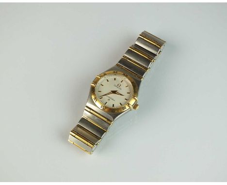 A Lady's Omega constellation stainless steel and gilt wristwatch, the cream dial with batons, the bezel with enamel Roman num