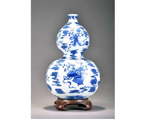 A Chinese blue and white gourd vase, Qianlong seal mark but laterOf swollen globular form and decorated with auspicious objec