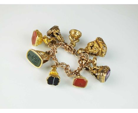A 9ct rose gold curb link bracelet, with attached fobs, comprising two polished bloodstone examples, three intaglio carnelian
