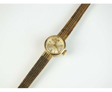 A ladies 9ct gold Rolex Precision bracelet watch, manual wind, the circular dial with gold batons, the integral 9ct gold tape