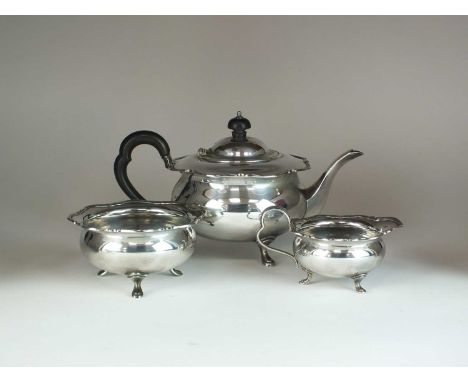 A three piece silver tea service, Atkin Brothers, Sheffield 1929, each piece of circular form with crimped rim, comprising; a