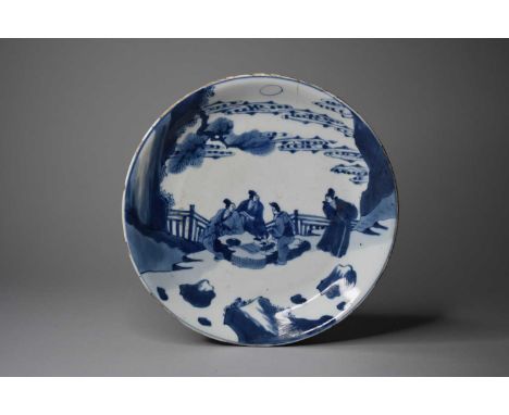 A Chinese blue and white dish, 18th centuryOf plain round form, decorated with a scene of four scholars gathered around a roc