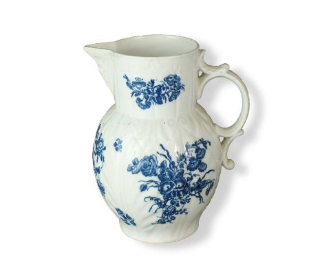 A Caughley mask-head cabbage leaf jugcirca 1785-90transfer-printed in underglaze blue with the Three Flowers pattern, printed