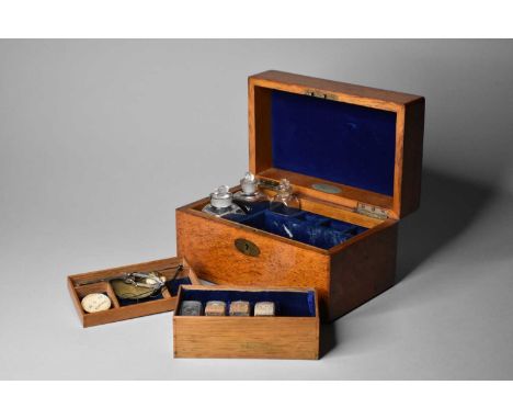 With an oval brass plaque and escutcheon, the interior fitted with two sets of scales and bottles and two removable trays, la