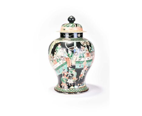 A Chinese famille noir jar and cover, KangxiOf baluster form, the domed cover with cone finial, decorated with a scene of sch