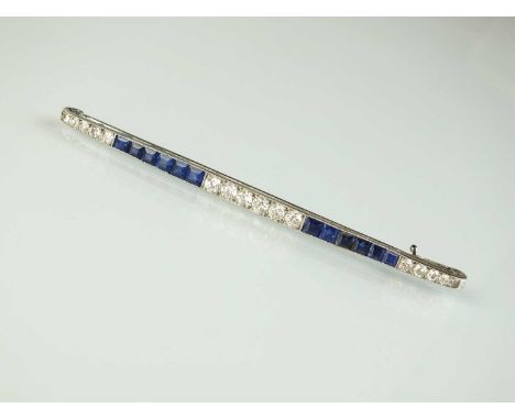 An Art Deco diamond and sapphire bar brooch, designed as a central row of six old cut diamonds, flanked to each side by a row