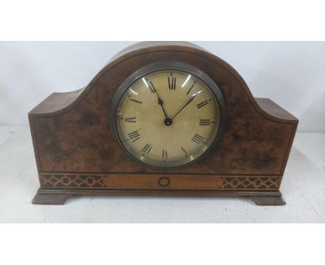 An early 20th century marquetry inlaid arched top mantel clock having a mark 'Swiss Made' to the dial and a Buren movementLoc