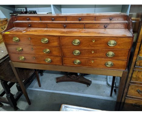 A 19th century mahogany bank of drawers on a later stand with gilt brass and mahogany button handles, the stand with square t